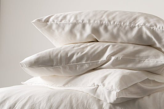 Stacked white eucalyptus lyocell pillowcases with a soft sheen